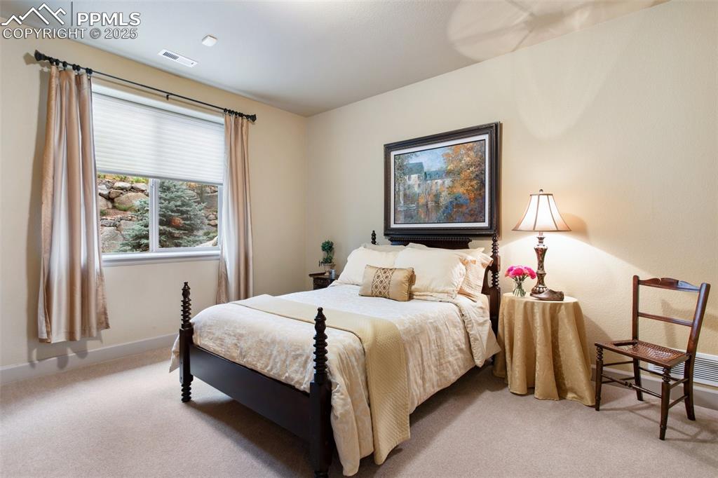 Image 32 of 49: Basement Bedroom #5 has neutral carpet and a generous closet.