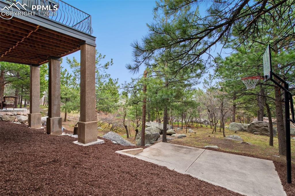Image 47 of 49: Built-in backyard basketball shooting court.