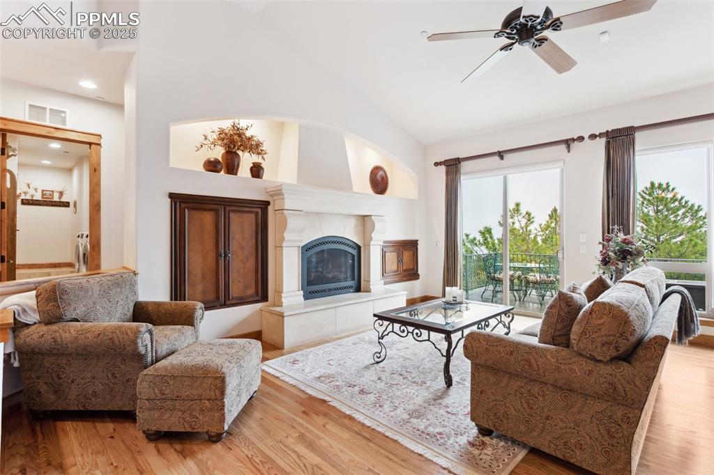 Image 8 of 49: The Great Room features hardwood floors, a fireplace with raised hearth, bu