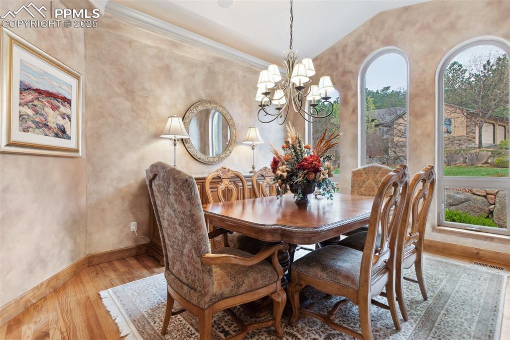 Image 9 of 49: The Formal Dining Room boasts hard wood floors, an attractive light fixture