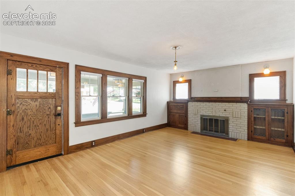 Image 13 of 33: solid hardwood floors, fireplace