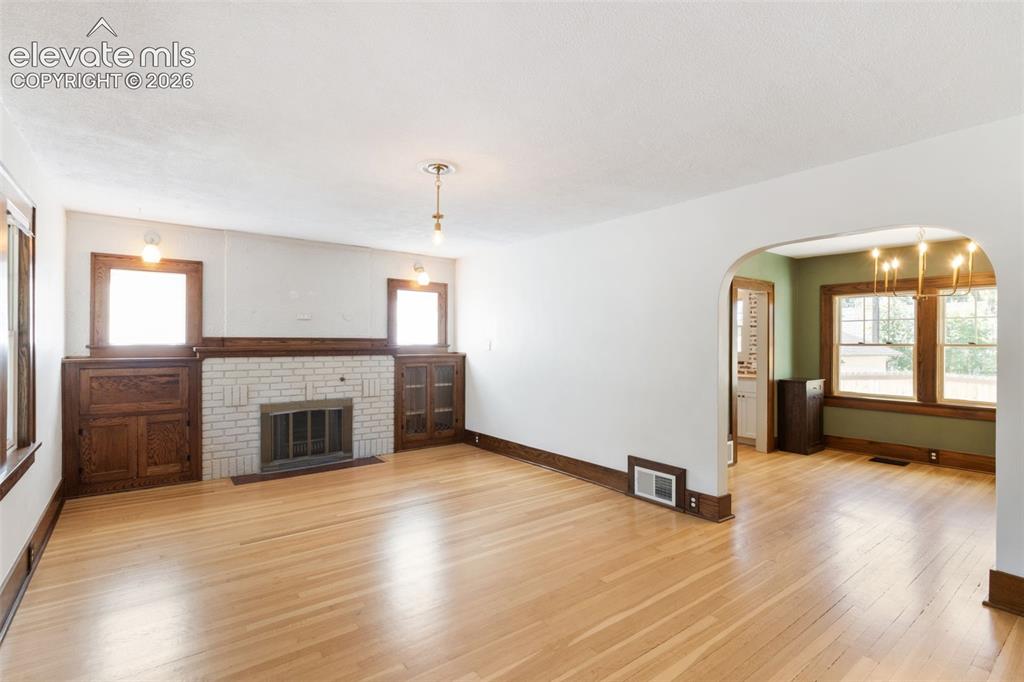 Image 16 of 33: solid hardwood floors, fireplace
