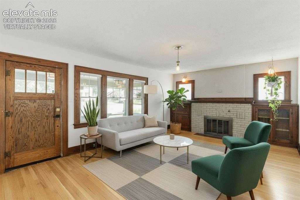 Image 4 of 33: solid hardwood floors, fireplace, virtually staged