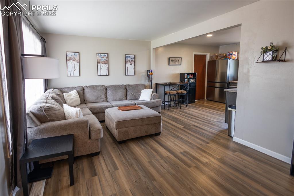 Image 2 of 11: Living area featuring dark wood finished floors
