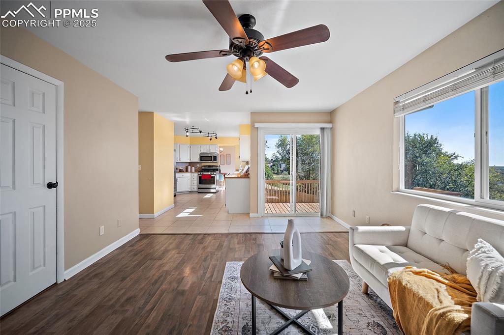 Image 19 of 45: Living room featuring light wood-style floors and ceiling fan