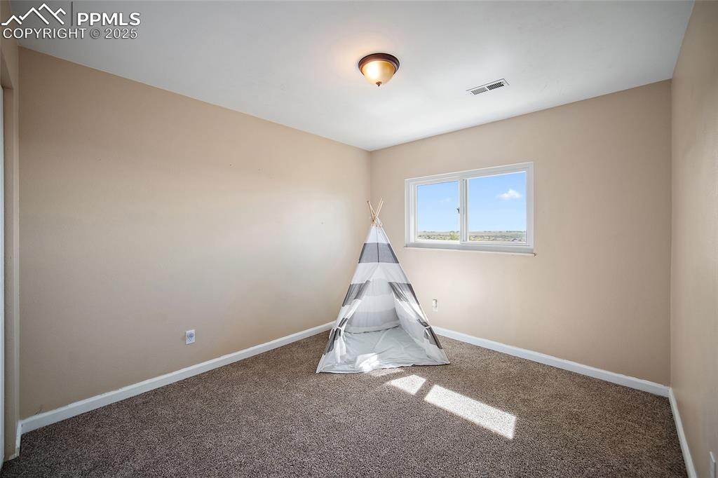 Image 27 of 45: Playroom featuring carpet floors and baseboards