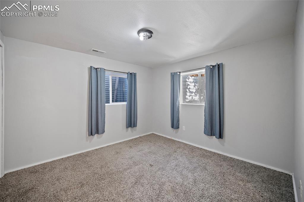 Image 33 of 45: Carpeted empty room with baseboards