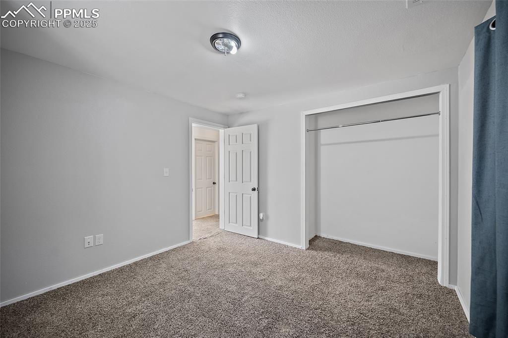 Image 34 of 45: Unfurnished bedroom with carpet floors and a closet