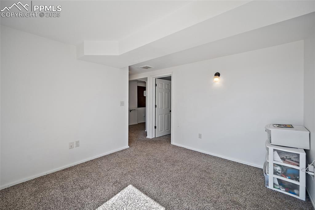 Image 37 of 45: Spare room featuring carpet floors and baseboards