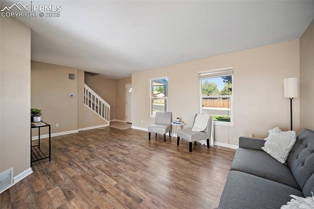 Image 9 of 45: Living area featuring wood finished floors and stairs