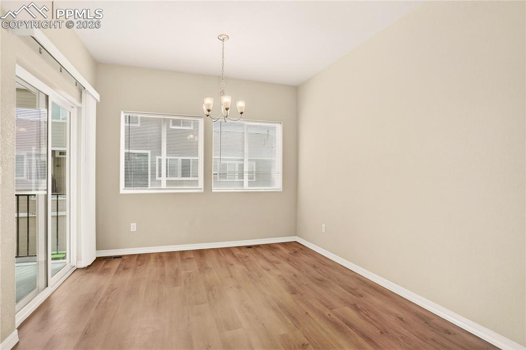 Image 11 of 38: Dining Room walks out to balcony - big windows bring in lots of light