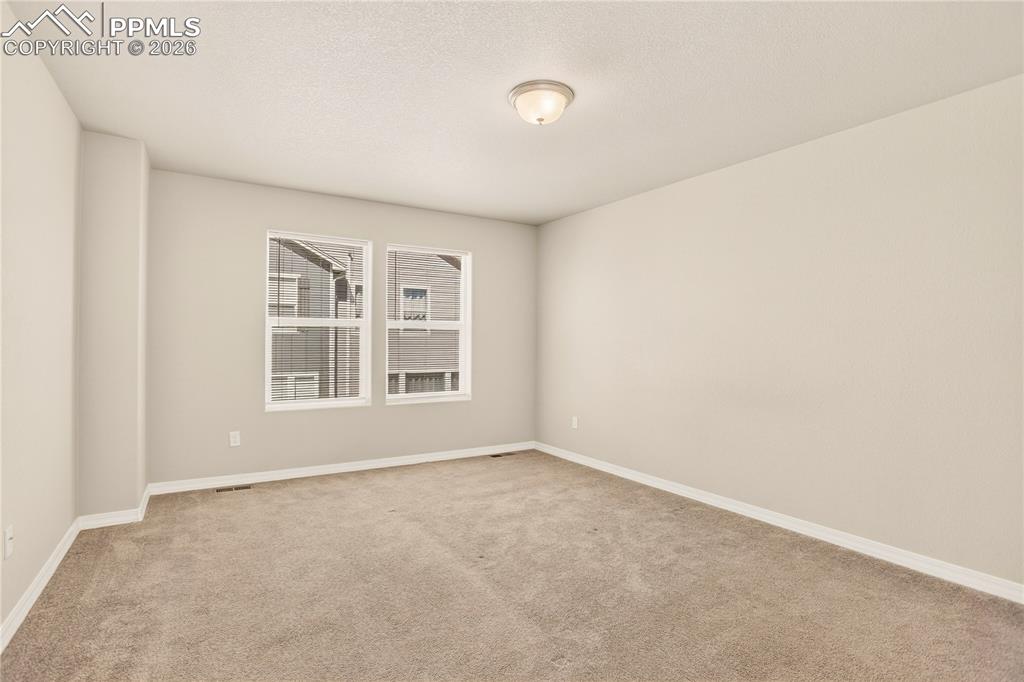 Image 22 of 38: Spacious primary bedroom with attached full bath