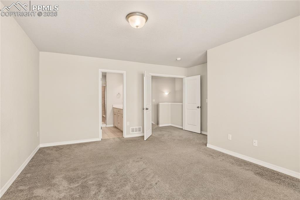 Image 23 of 38: Primary suite with large walk-in closet