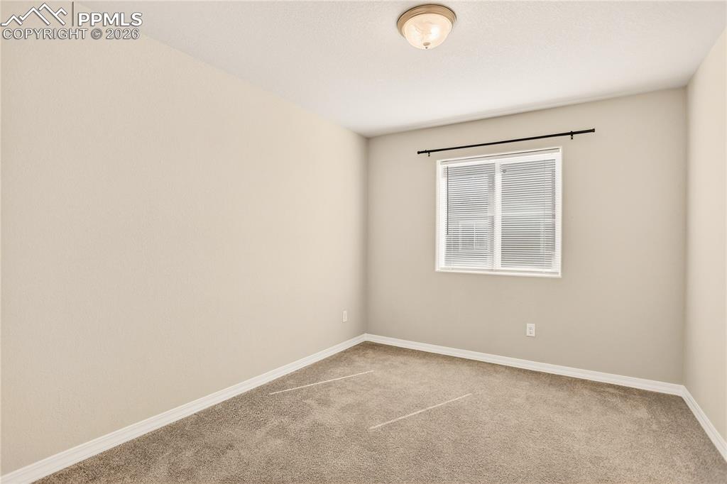 Image 26 of 38: Upper level Secondary bedroom 2 is carpeted and has roomy closet