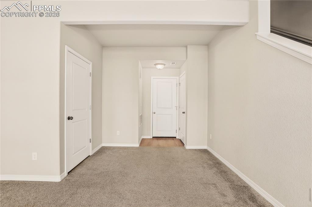 Image 33 of 38: Entry level flex space with half bath