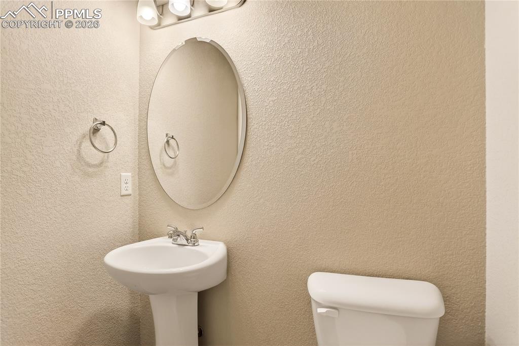 Image 34 of 38: Powder room on entry level