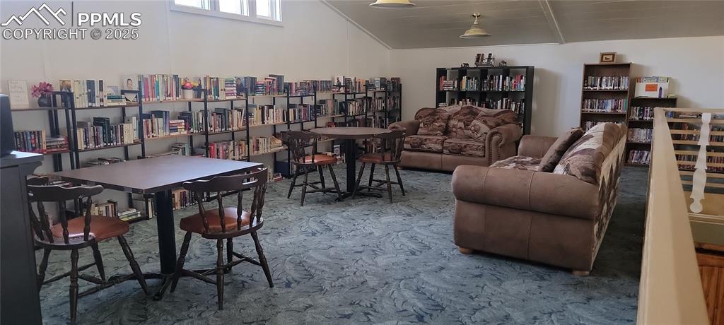 Image 13 of 23: Sitting room featuring lofted ceiling and carpet flooring