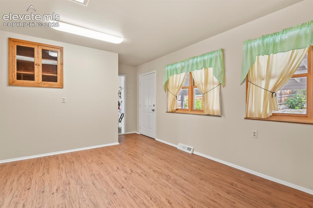 Image 14 of 45: Corner of kitchen looking toward back door to patio and door to workshop (h