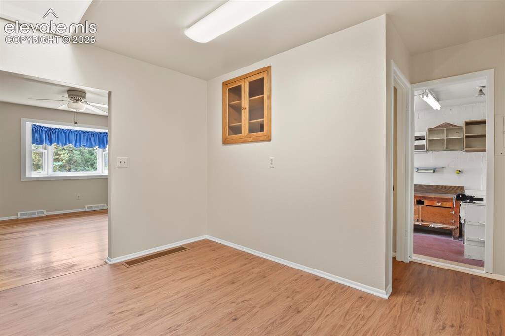 Image 15 of 45: Entrance to living room, workshop area, and doorway to the basement.