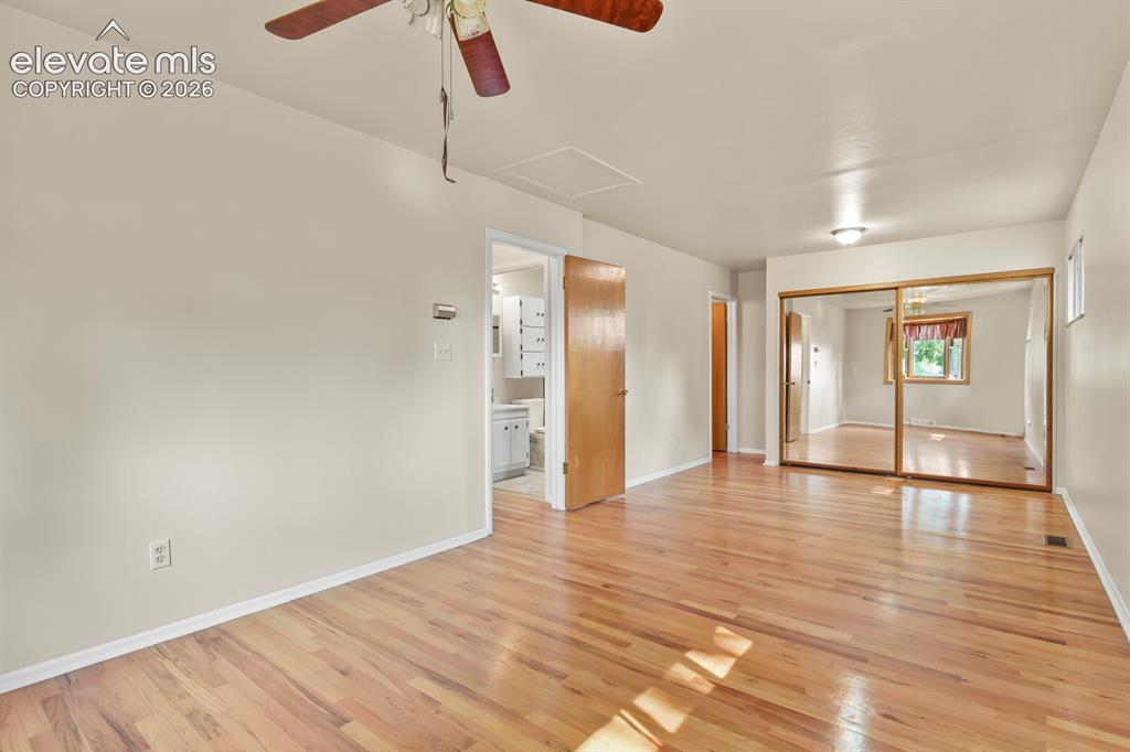Image 17 of 45: Corner of Primary Bedroom looking toward entrance to the hallway, main bath