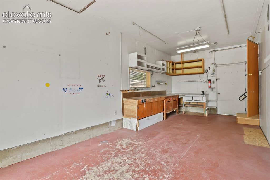 Image 24 of 45: One-car garage converted to workshop/hobby room.