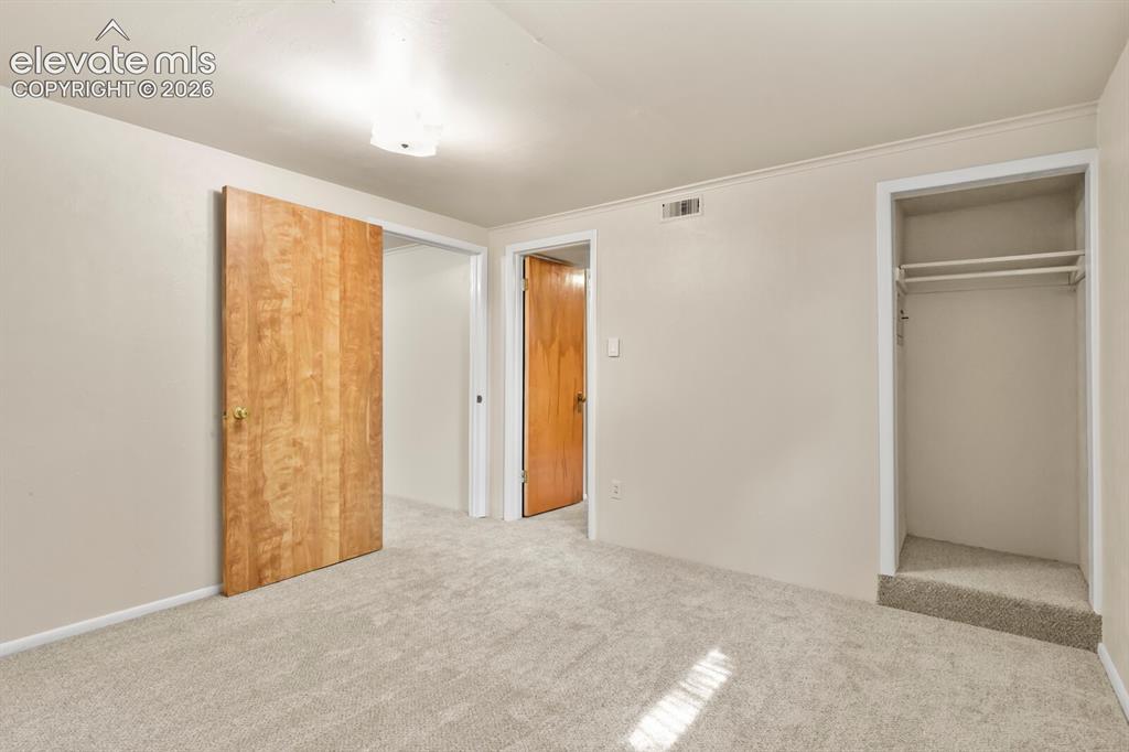 Image 30 of 45: Inside back-corner basement bedroom looking towards Family Room entrance an