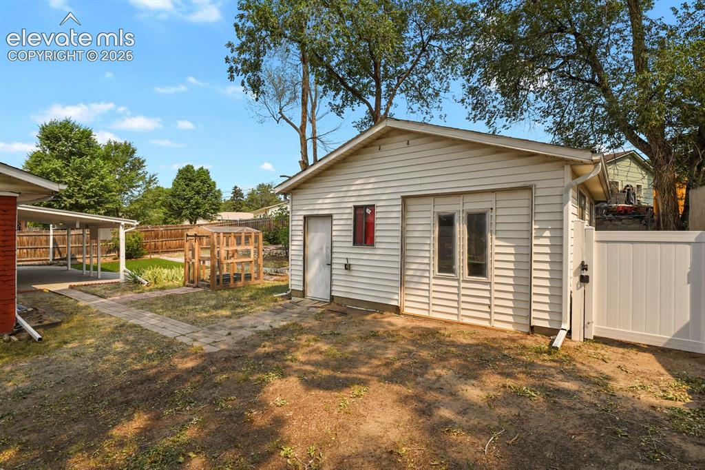 Image 35 of 45: Detached shop with a usable door on right side for car entrance.