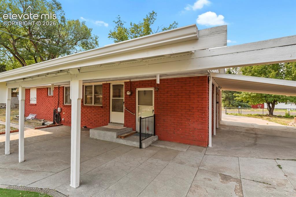 Image 39 of 45: View of covered patio and carport.