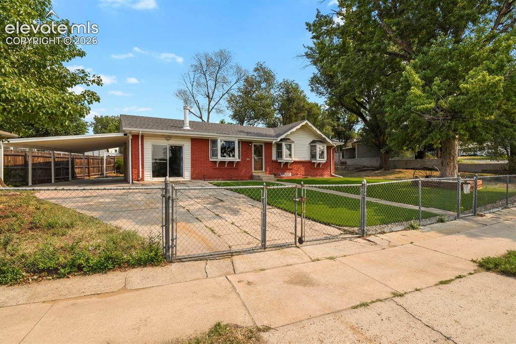 Image 4 of 45: Front fence, house and carport.