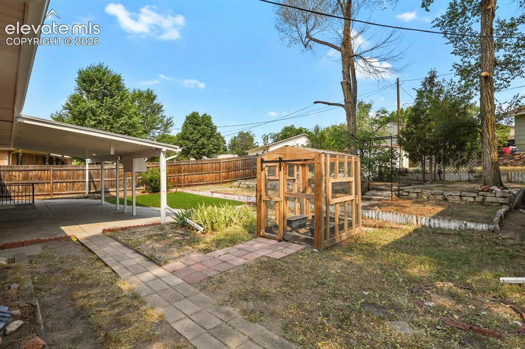 Image 41 of 45: Backyard and covered patio.