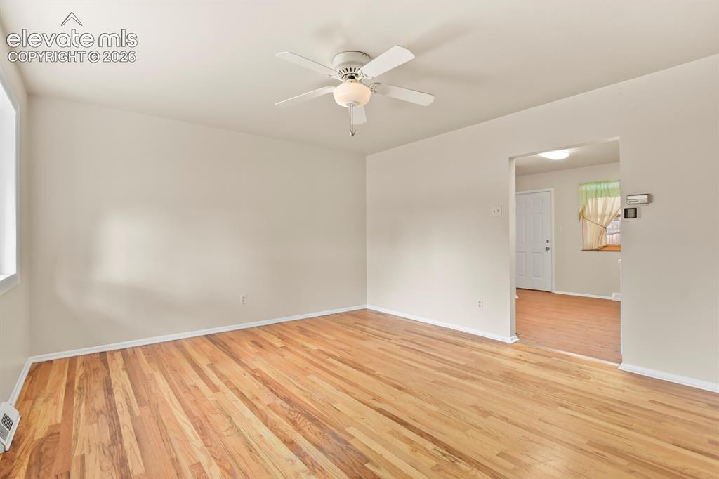 Image 5 of 45: From front door looking into living room and kitchen.