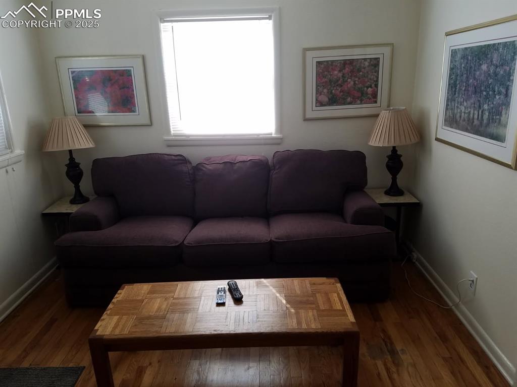 Image 14 of 25: Living room with baseboards and wood finished floors