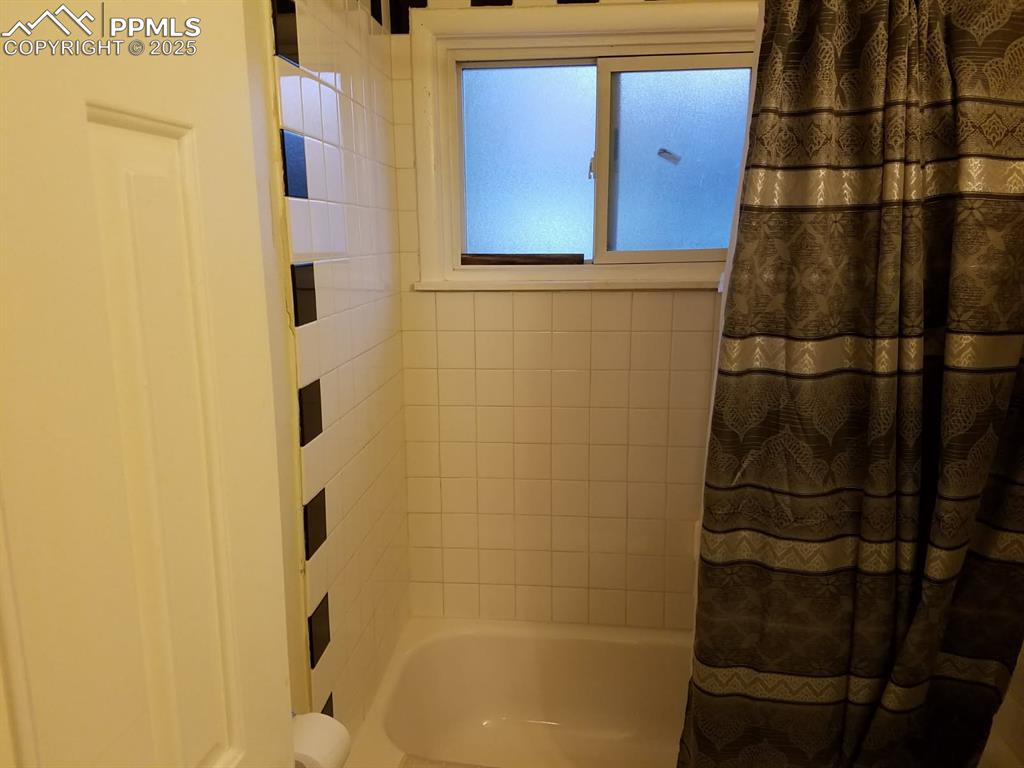 Image 19 of 25: Bathroom featuring shower / bath combo