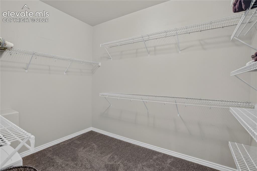 Image 13 of 29: Walk-in closet for primary bedroom