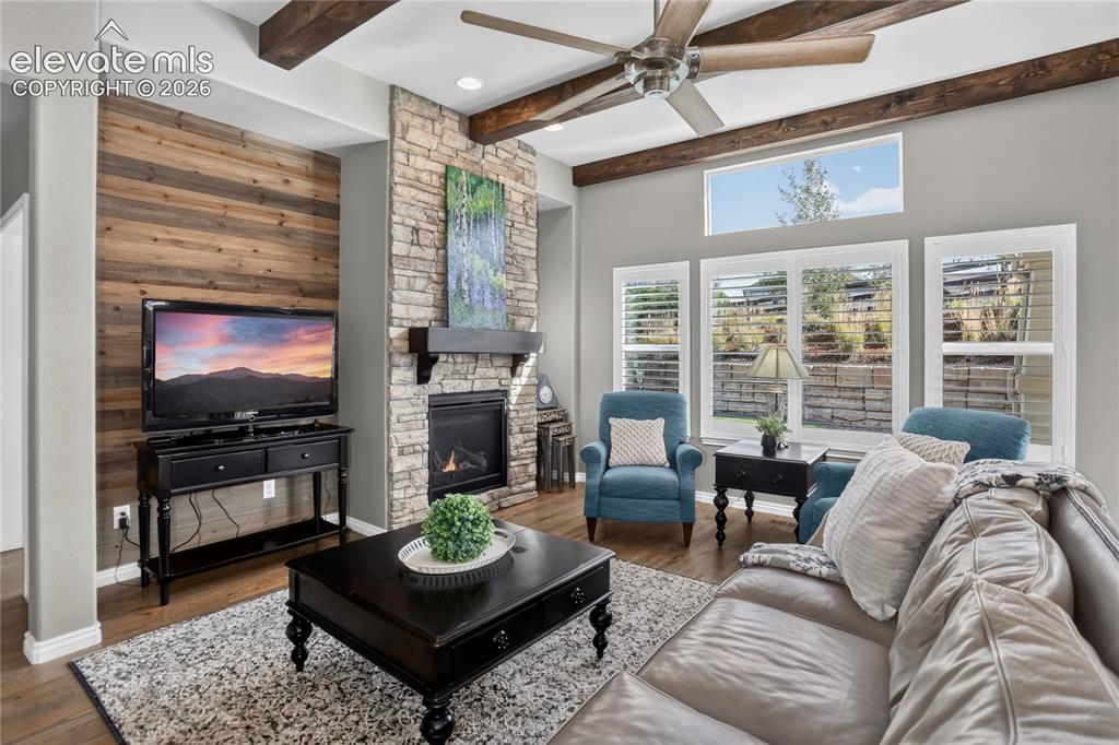 Image 3 of 29: Living room w/ fireplace and beam detailing