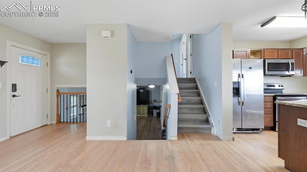 Image 14 of 34: Living Room with stairs to the upper level.