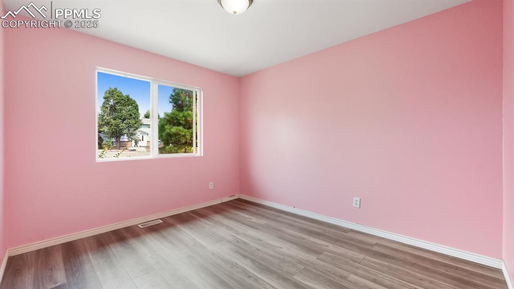 Image 15 of 34: Upper Level Bedroom #1 with LVP floors.