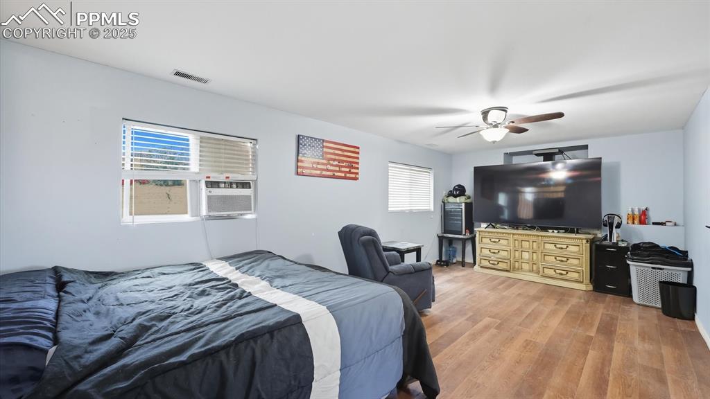 Image 23 of 34: The Lower Level Family Room features LVP floors, a lighted ceiling fan, and