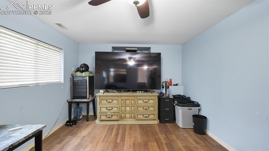Image 24 of 34: The Lower Level Family Room has a wood burning stove (behind the TV) to coz