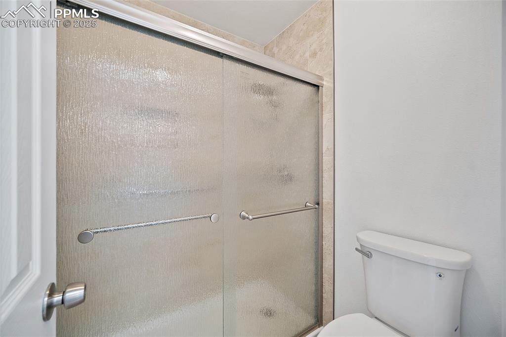 Image 22 of 41: Bathroom with a shower with shower door