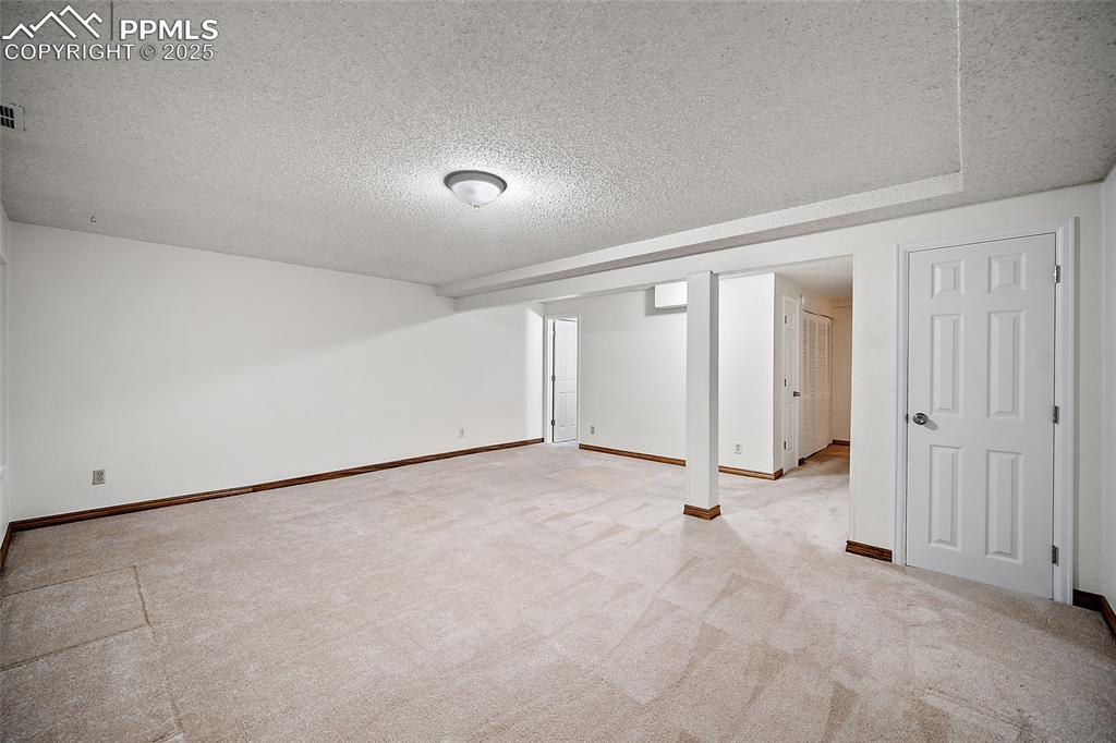 Image 26 of 41: Spare room featuring a textured ceiling and light colored carpet