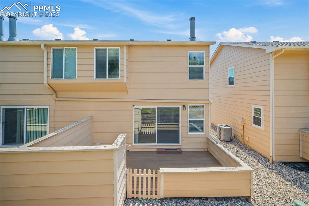 Image 33 of 41: Rear view of property featuring a wooden deck