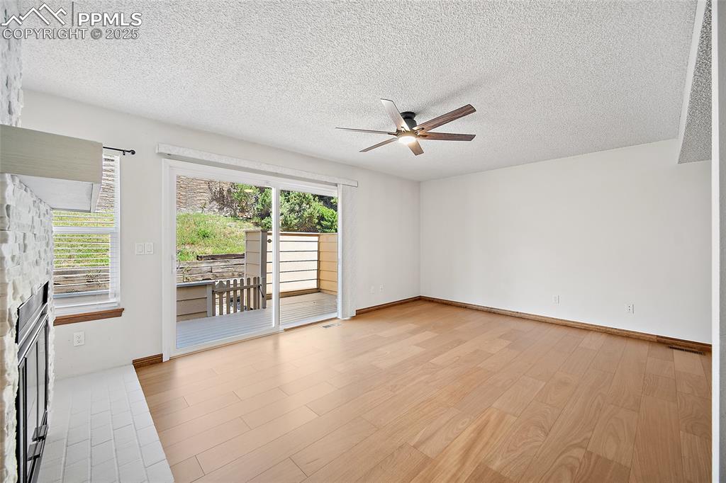 Image 5 of 41: Spare room featuring a textured ceiling, light wood-type flooring, and a ce