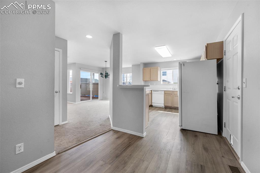 Image 11 of 27: Kitchen looking into dining room