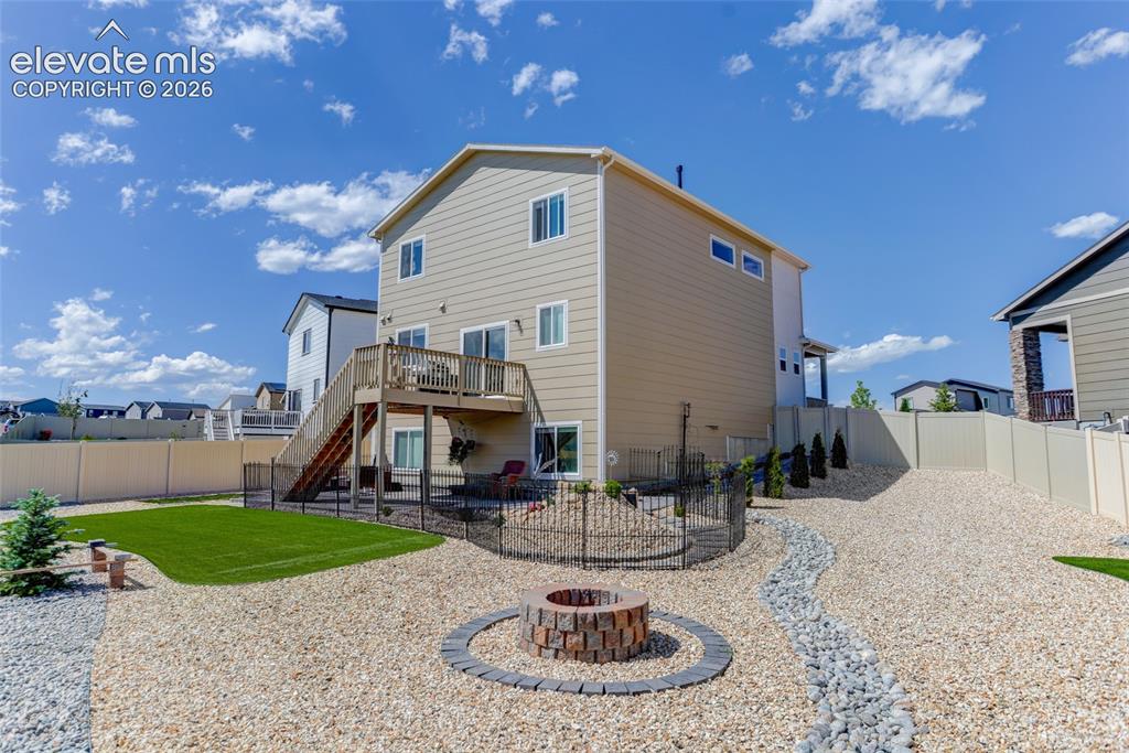 Image 27 of 30: Fully fenced yard with firepit