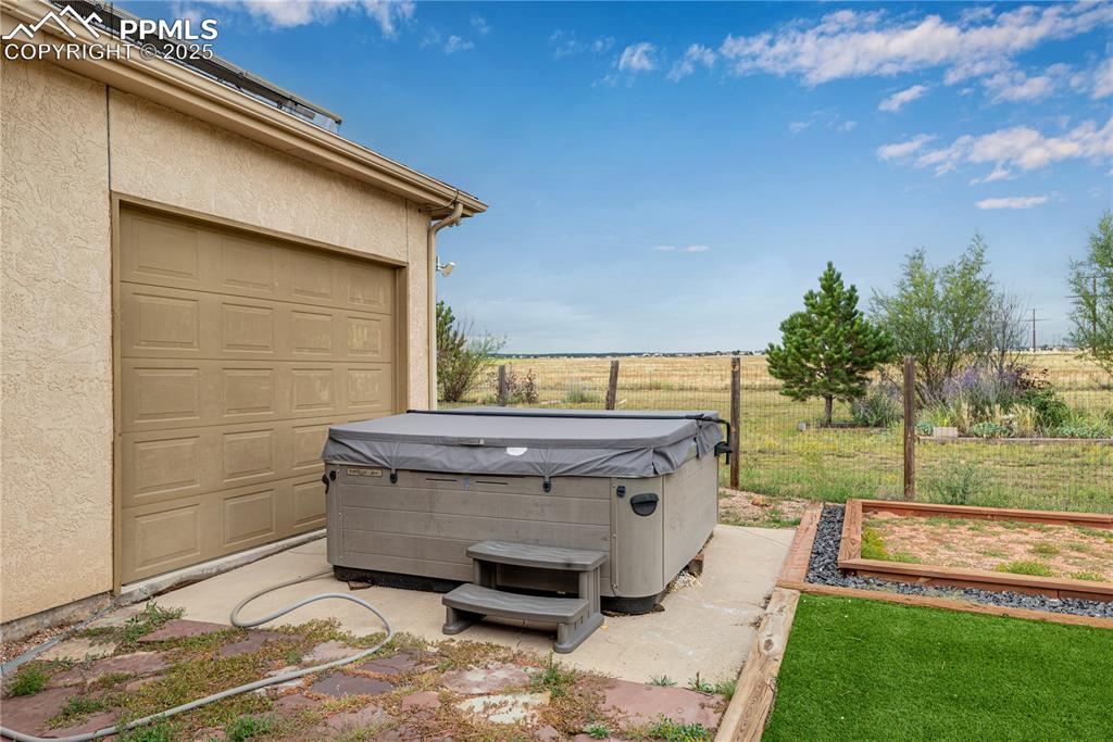 Image 10 of 48: View of patio / terrace featuring a view of countryside and a hot tub