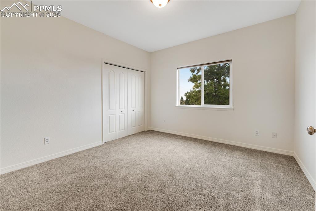 Image 29 of 48: Unfurnished bedroom with light colored carpet and a closet