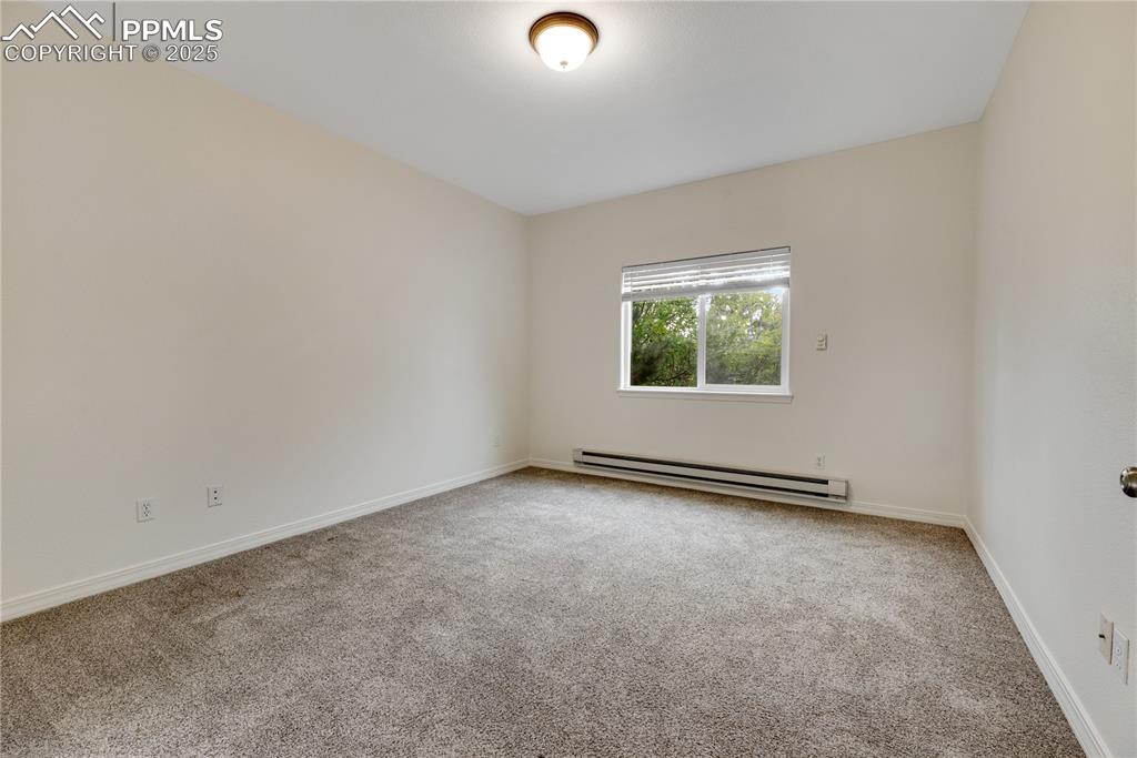 Image 30 of 48: Unfurnished room with light carpet and baseboard heating