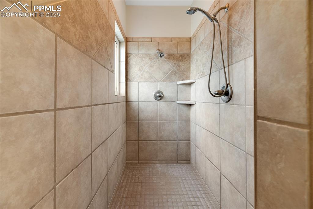 Image 41 of 48: Bathroom featuring tiled shower