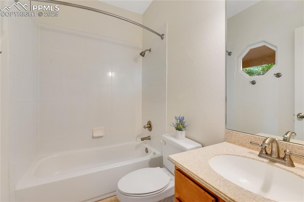 Image 42 of 48: Full bath with shower / bath combination, vanity, and a textured wall